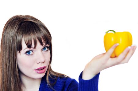 young  woman with yellow paprika の写真素材
