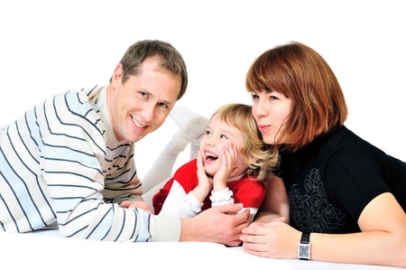 laughing family laying over the whiteの写真素材