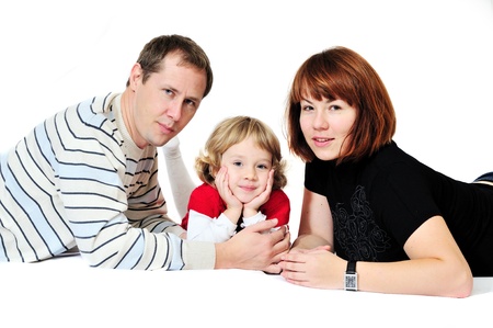 mother, father and daughter laying on over the white の写真素材