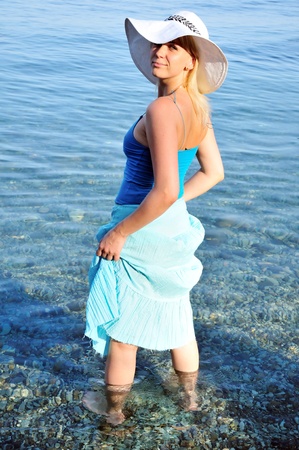 nice young lady in white hat in the  blue sea の写真素材
