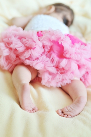 dreams of baby princess (2 monthes girl sleeping wearing pink skirt)の写真素材
