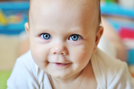 portrait of sweet smiling blue-eyed babyの写真素材