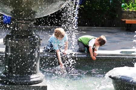 two little boys having fun near waterworks の写真素材