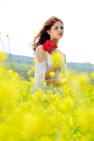 beautiful girl on rapeseed field in bloomの写真素材