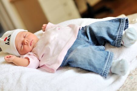 cute newborn girl wearing jeansの写真素材