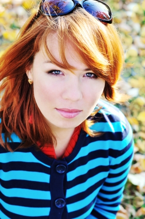 bright ginger woman in fall timeの写真素材