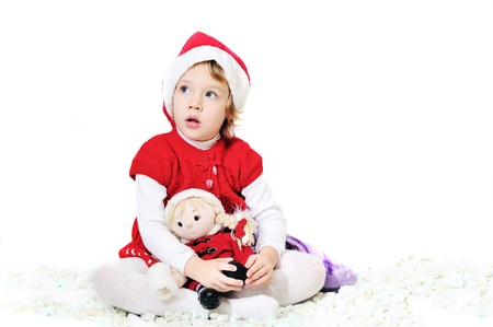 happy playing santa girl sitting with dollの写真素材