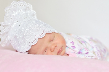 sweet newborn girl dreaming at home の写真素材
