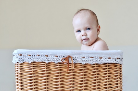 funny baby sitting in the basketの写真素材