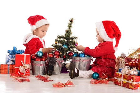 two  santa helpers decorating a treeの写真素材