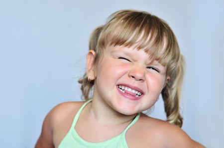 funny girl making face and showing tongue
