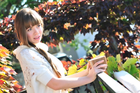 tender girl drinking cup of tea in fall timeの写真素材