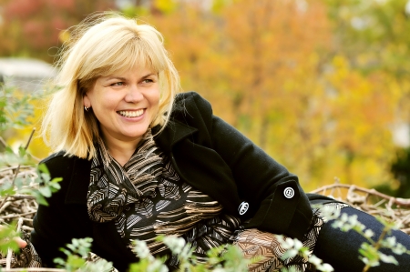 happy middle aged woman in fall timeの写真素材