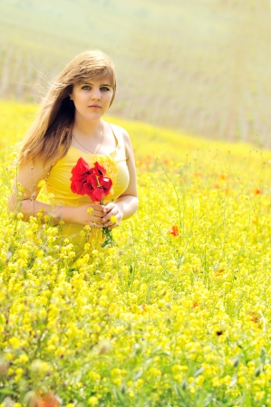 girl with bouquet of poppies in the raps fieldの写真素材