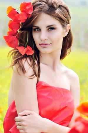 attractive girl with poppies in hairの写真素材