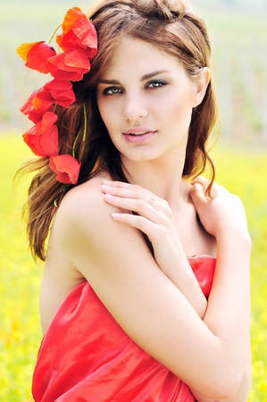 tender girl with poppies in her hairの写真素材