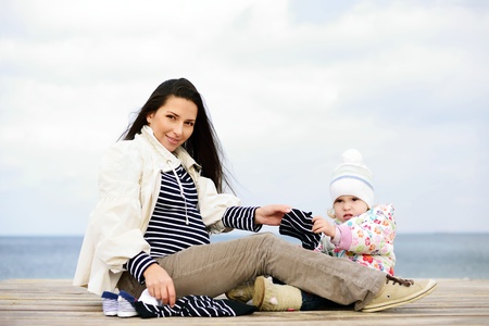 pregnant mother with daughter awaiting babyの写真素材