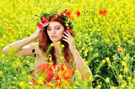 redhead girl with crown from field'd flowersの写真素材