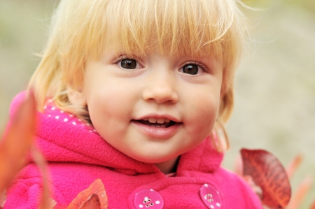 smily toddler girl in fall timeの写真素材