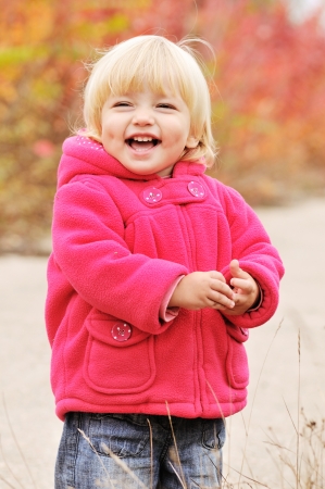 happy blonde baby with dimple cheeksの写真素材