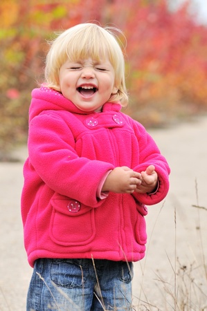 laughing baby girl on autumn backgroundの写真素材