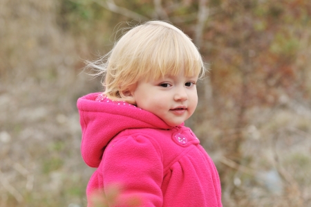 baby girl walking in the forestの写真素材