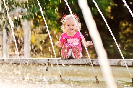 toddler girl on the fountainの写真素材