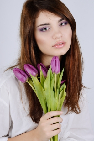 Beautiful tender girl with tulipsの写真素材
