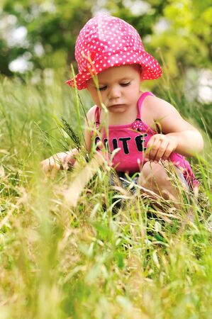 cute baby in grass in summer timeの写真素材