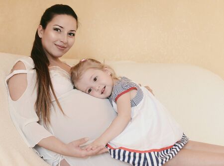 pregnant mother with loving daughter in soft selective focusの写真素材