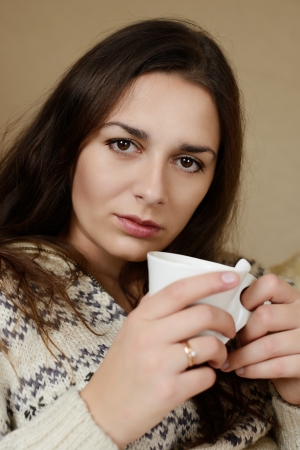 young brunette with cup of morning coffeeの写真素材