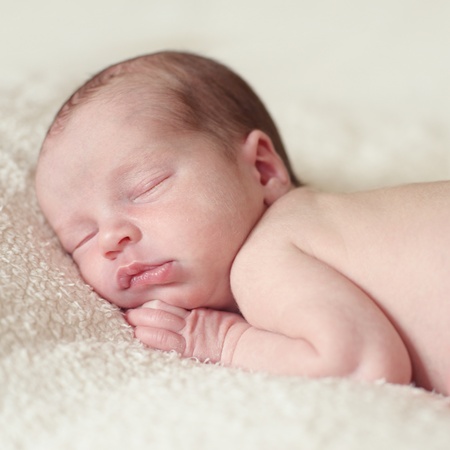 sweet little newborn sleepung on the blanketの写真素材