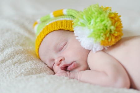 sweet sleeping newborn wearing funny hatの写真素材