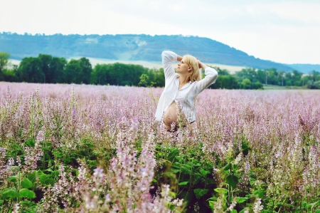 pregnant woman  standing in fieldの写真素材