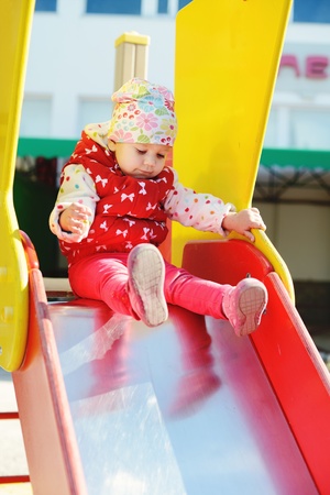cute toddler on slide on the playgroundの写真素材