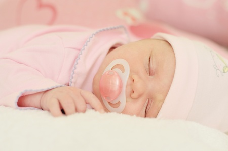 newborn girl sleeping with dummyの写真素材