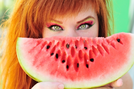 redhead girl holding fresh watermelonの写真素材