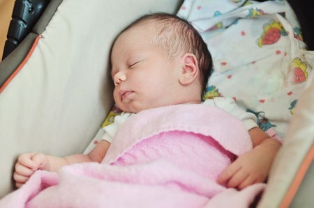 newborn sweet girl sleeping in pramの写真素材