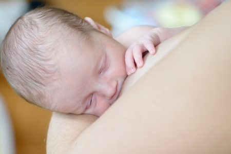 Breast-feeding of the newborn baby in soft selective focusの写真素材