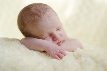 two weeks old newborn sleeping over the pillowの写真素材