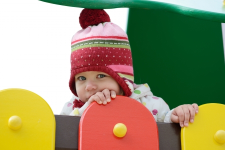 shy toddler on the playground over the whiteの写真素材
