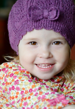 cute toddler girl wearing lilac hatの写真素材