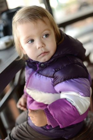 cute toddler sitting in cafeの写真素材
