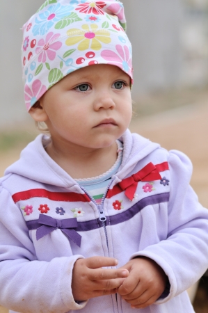 portrait of thoughtful toddler girl outdtoorsの写真素材