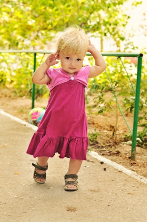 running baby girl with fair hairの写真素材