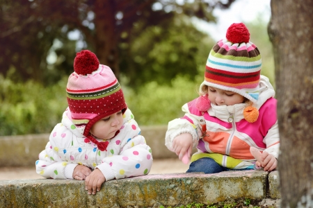two girls drawing with chalk in parkの写真素材