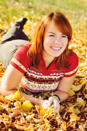 happy  redhead woman in fall parkの写真素材