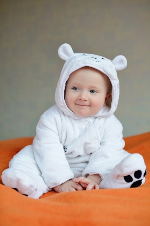 funny smiling  baby wearing costume of polar bearの写真素材