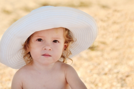 summer toddler girl wearing big hatの写真素材
