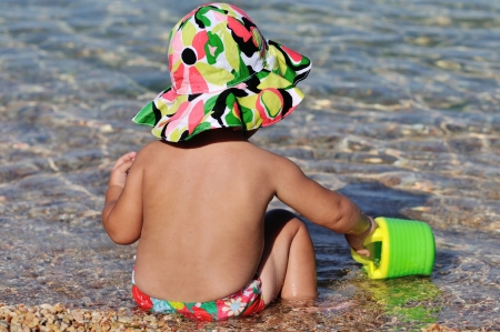 summer baby playing in the seaの写真素材